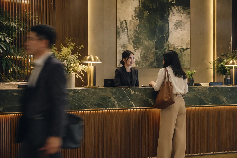 A commercial building reception with a tenant passing in the foreground