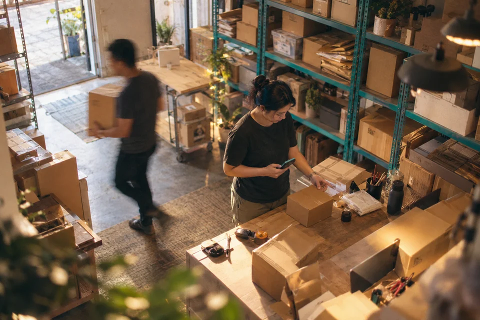 A startup team coordinating orders in a packing room