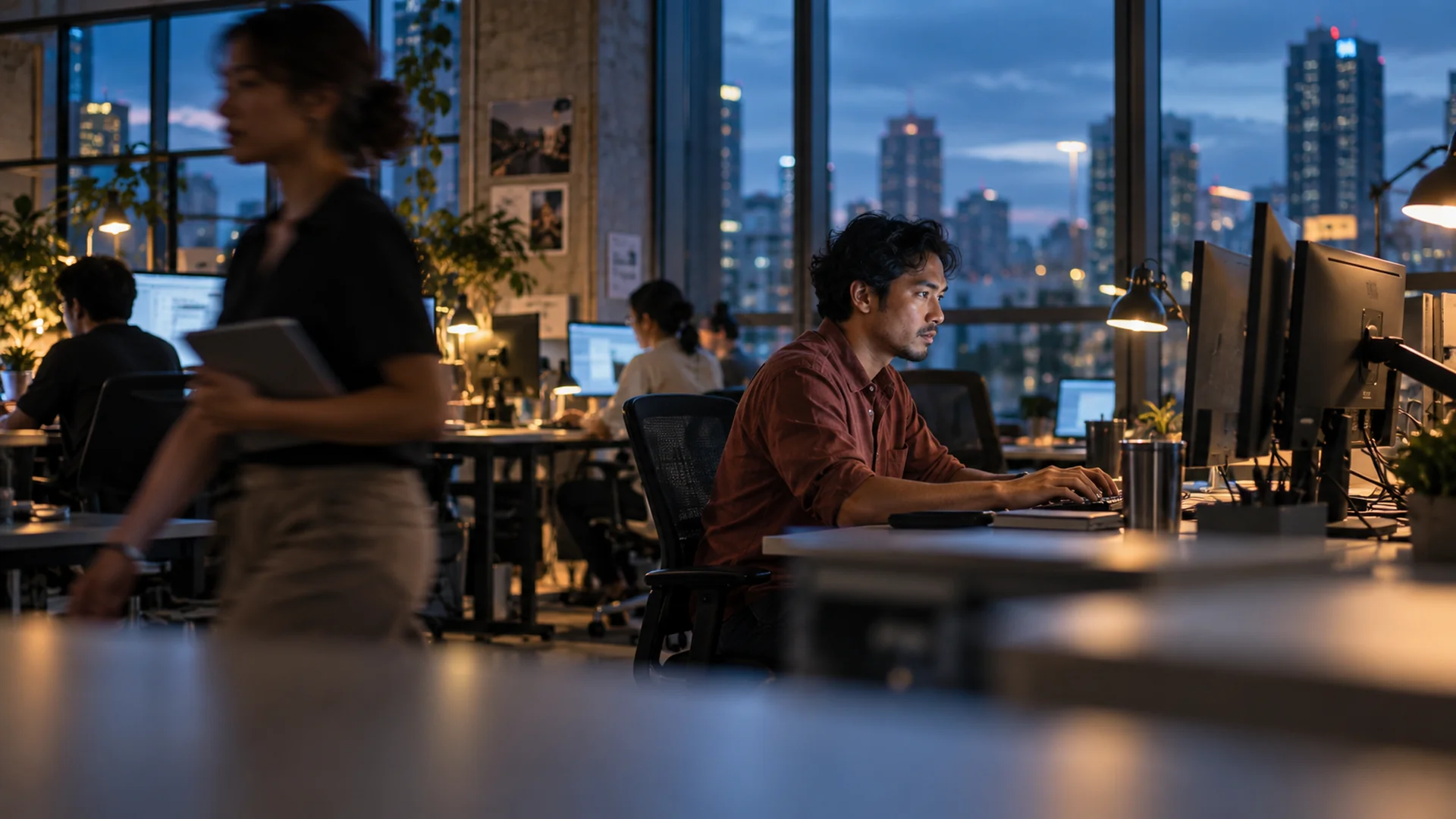 An engineer working in a software studio at blue hour