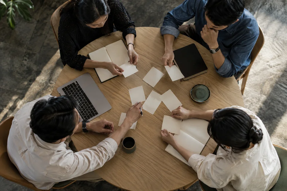 Participants working through exercises around a round table